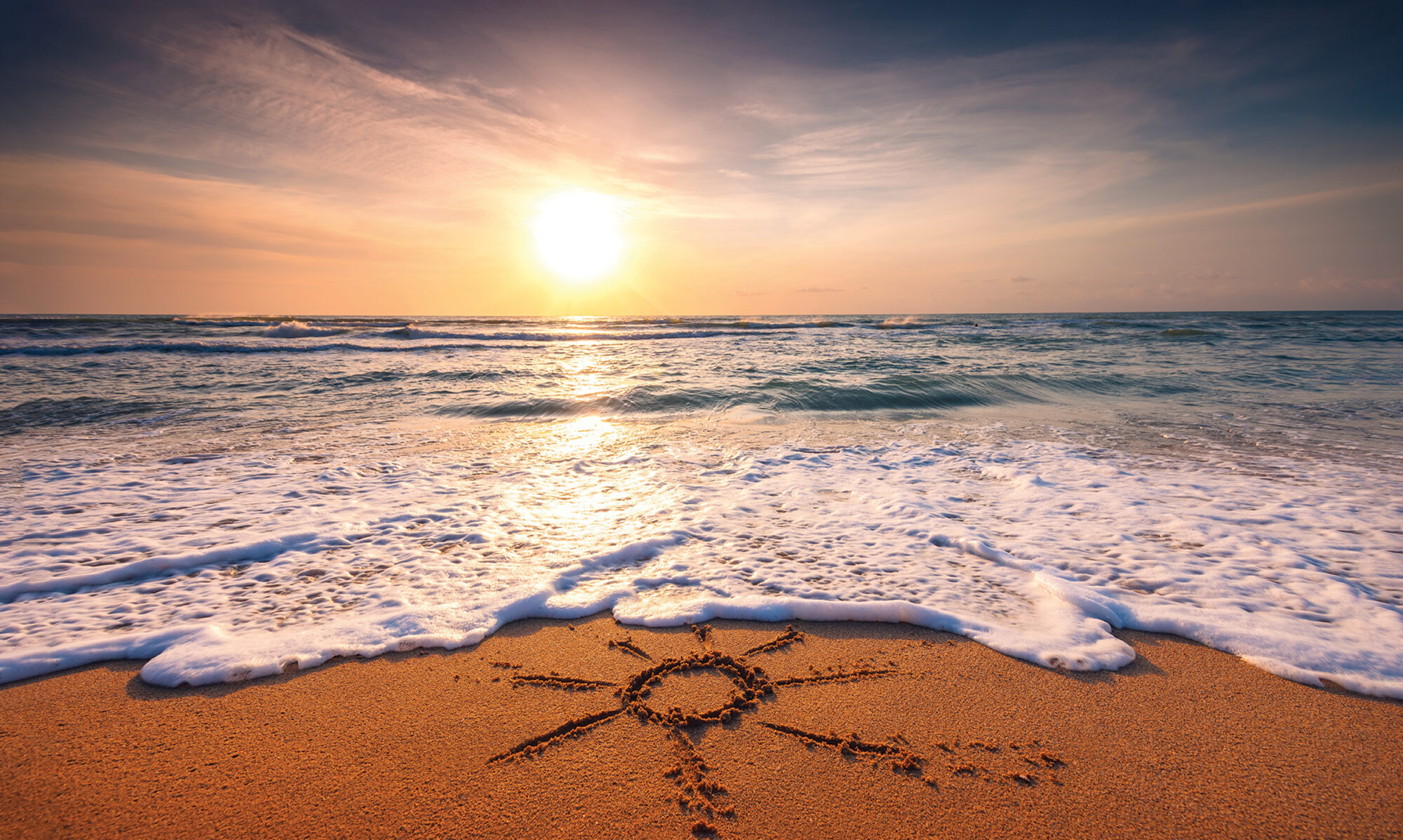 beach sunset with sun drawn into sand